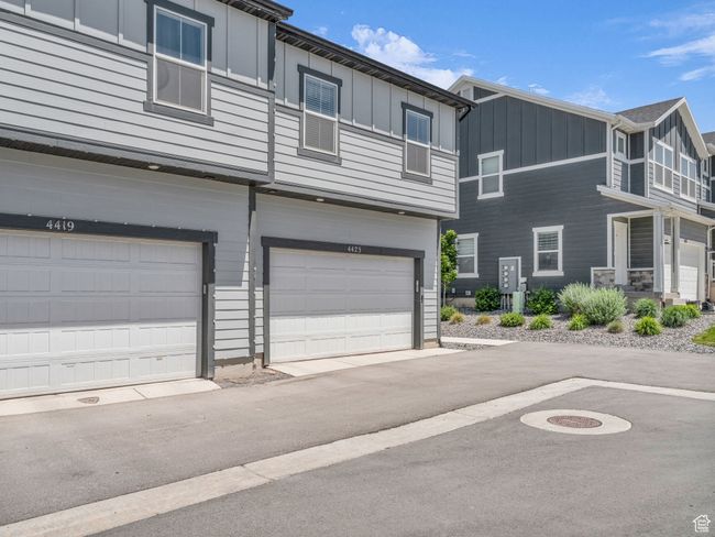View of front of home with board and batten siding and a garage | Image 25