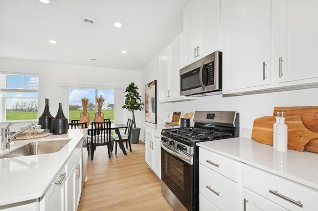 (Photo of decorated model, actual home's finishes will vary) Beautiful stainless steel appliances in the kitchen. | Image 4