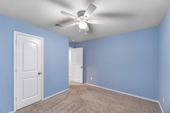 One of the two secondary bedrooms upstairs, complete with a large walk-in closet. | Image 35