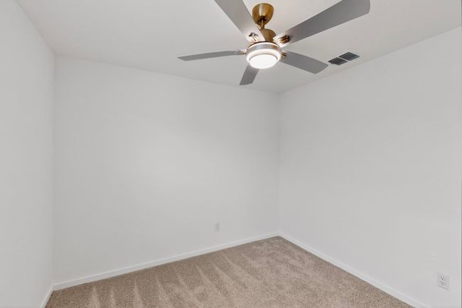 Empty room with light colored carpet, baseboards, and ceiling fan | Image 27