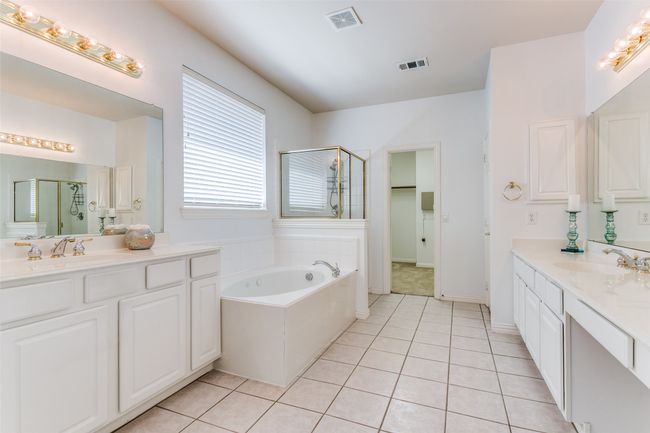 En suite bath features dual vanities, tub and separate shower, and huge closet! | Image 15