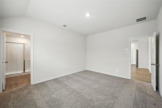Unfurnished bedroom featuring carpet flooring, lofted ceiling, and recessed lighting | Image 14