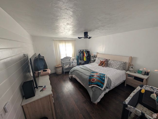 Bedroom with a textured ceiling, hardwood / wood-style floors, and a ceiling fan | Image 17