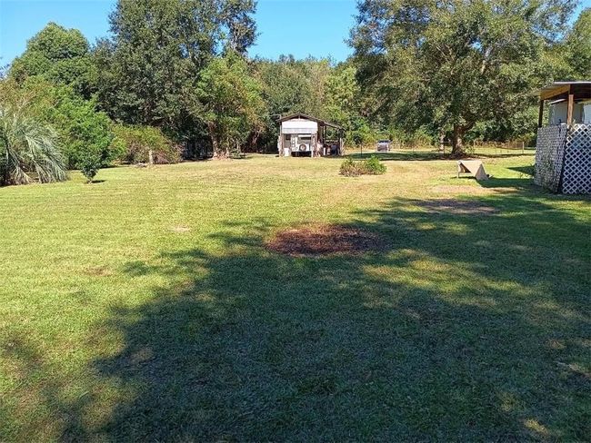 View of yard featuring a detached carport | Image 13