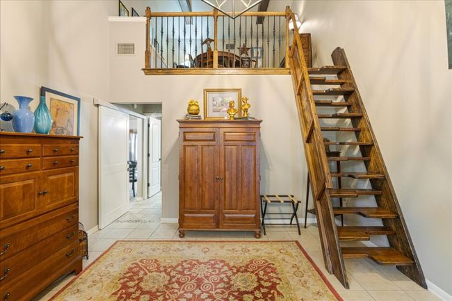 Stairs with visible vents, a high ceiling, tile patterned flooring, and baseboards | Image 27