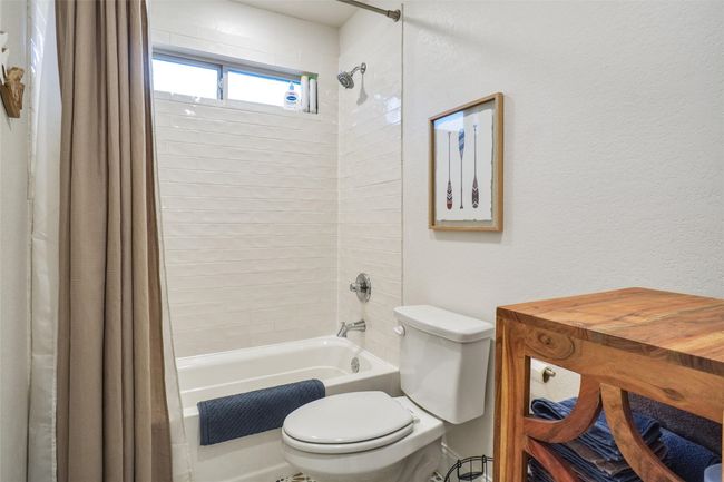 Bathroom with shower / tub combo with curtain and toilet | Image 20