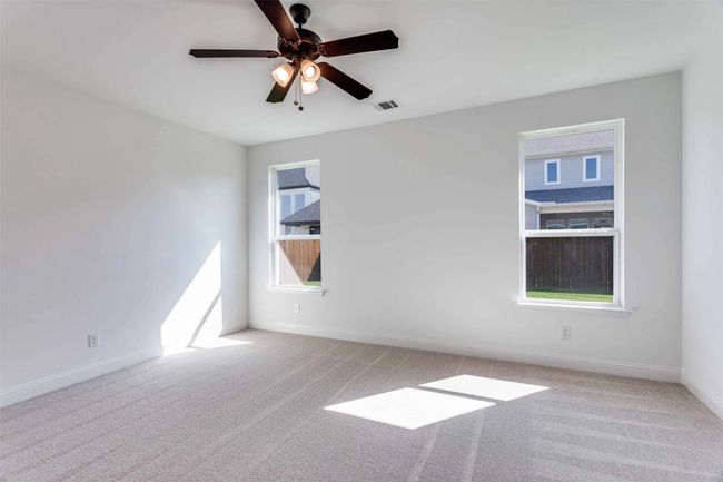 Carpeted empty room featuring ceiling fan | Image 11