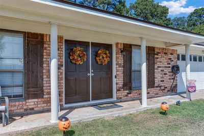 View of exterior entry featuring covered porch and a garage | Image 2