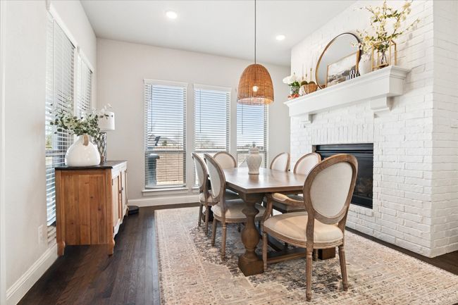 Dining room featuring recessed lighting, dark wood-style flooring, a fireplace, and baseboards | Image 7
