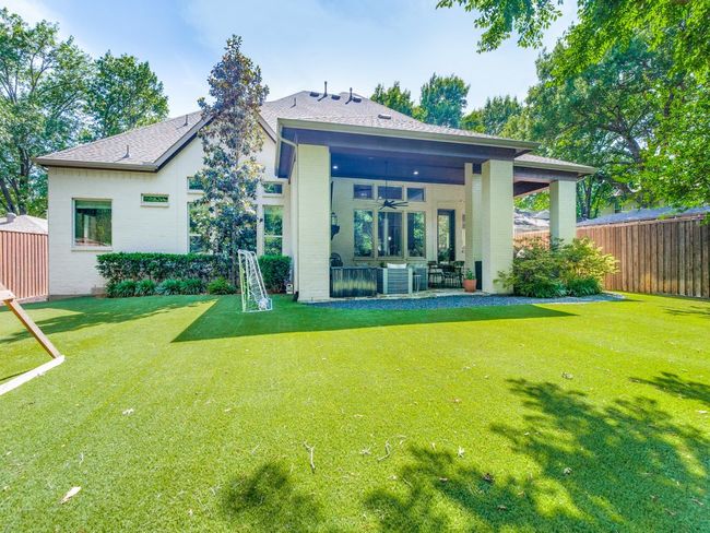 Rear view of house with a ceiling fan, brick siding, and a patio | Image 20