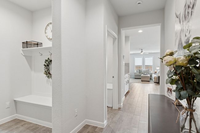Hall featuring light wood-style flooring and baseboards | Image 5