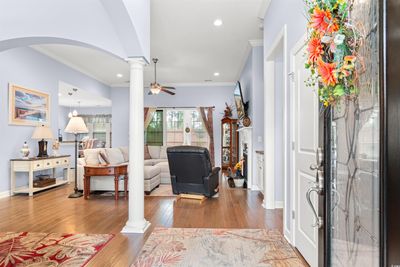 Entryway with ceiling fan, crown molding, light hardwood / wood-style floors, and ornate columns | Image 2