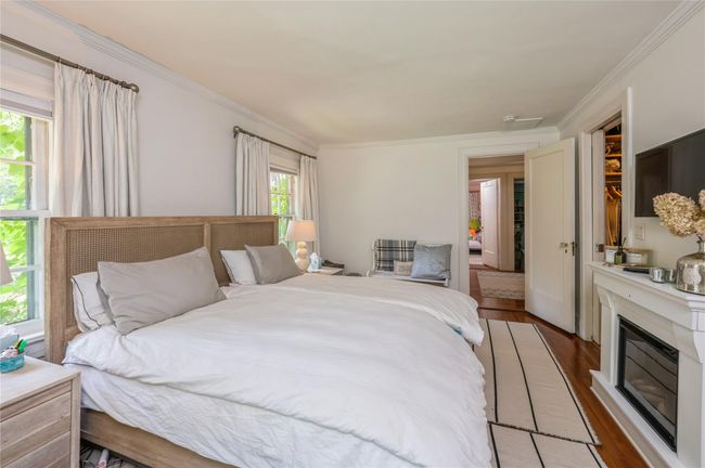 Primary bedroom enjoys a large, custom-outfitted walk in closet. | Image 21