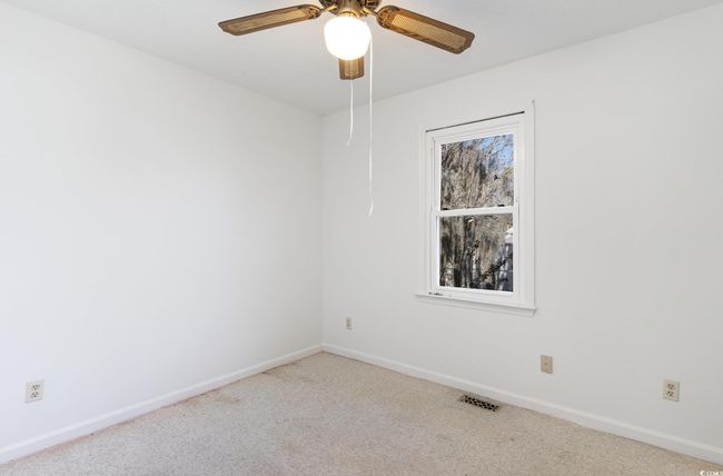 Carpeted empty room featuring ceiling fan | Image 19