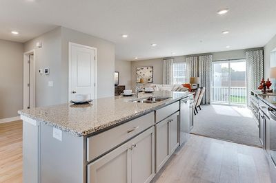 Plenty of counter space, plenty of storage, and a vented microwave fan make mealtime more enjoyable! Model home, details will vary. | Image 1