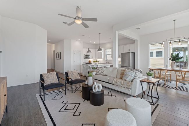 Inside the entryway flows past the secondary bedroom hallway into a luminous open floor plan living space. | Image 10