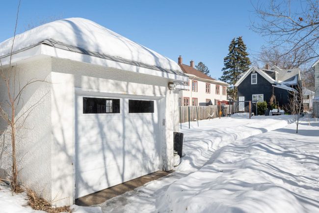 The garage is a single stall with electric opener and a little bit of elbow room for storage or a workbench. | Image 34