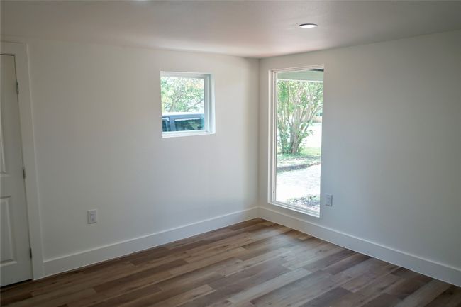 Spare room with healthy amount of natural light and wood finished floors | Image 4