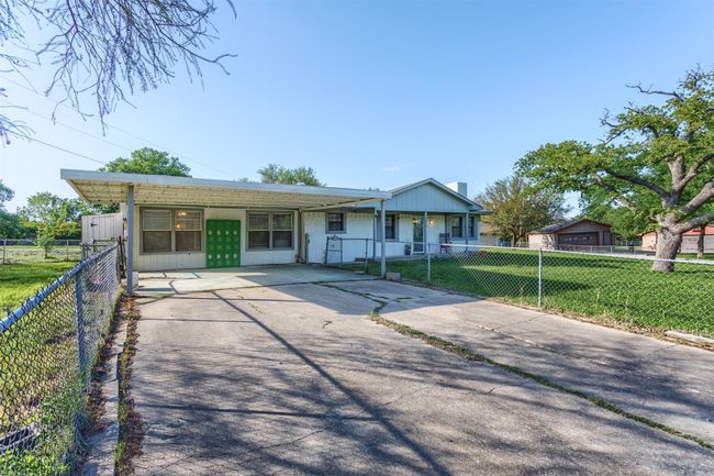 Single story home with concrete driveway, a front lawn, and a fenced front yard | Image 31