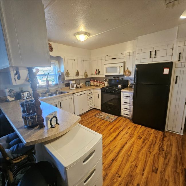 View of kitchen including gas range | Image 11