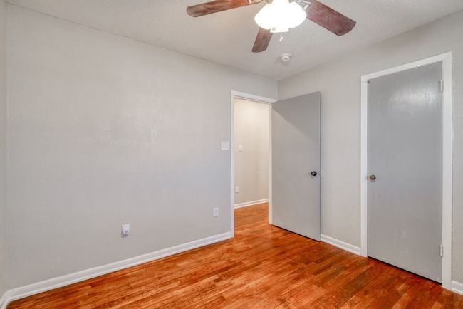 Bedroom 1 looking towards hallway. Original wood flooring. | Image 15