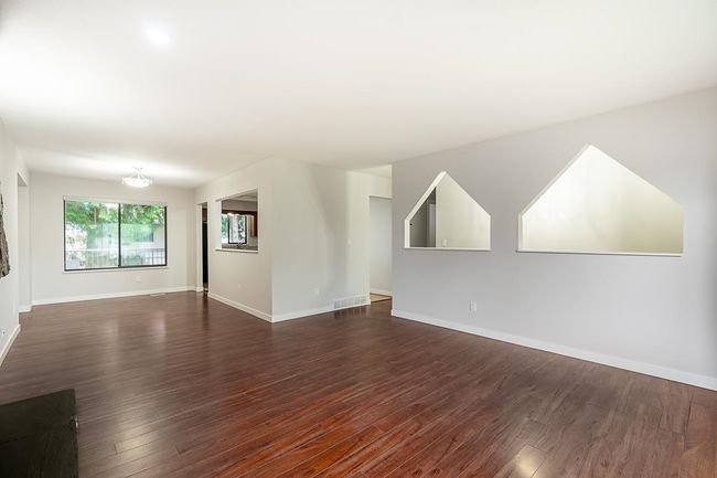 Unfurnished living room featuring dark wood finished floors | Image 4