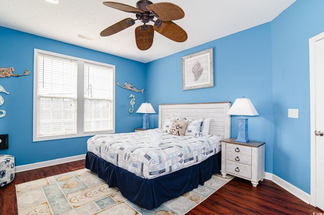 Bedroom featuring wood finished floors, baseboards, and ceiling fan | Image 28