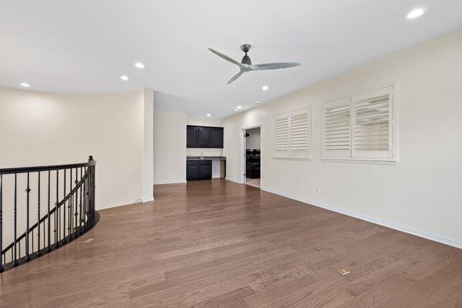 Unfurnished living room with wood finished floors, ceiling fan, and recessed lighting | Image 26
