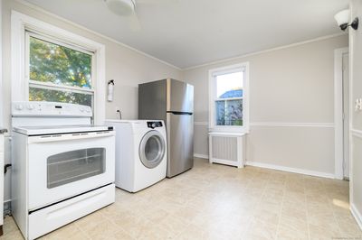 Kitchen with laundry, unit 1. | Image 3