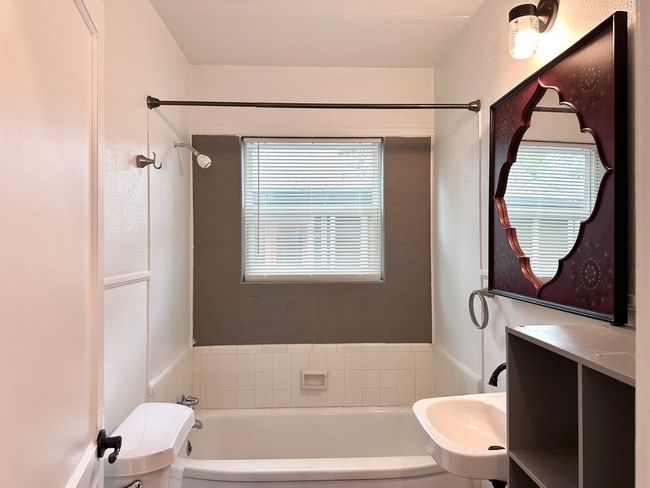Full bath featuring a sink and washtub / shower combination | Image 12