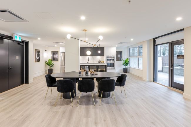 Kitchen with appliances with stainless steel finishes, light wood finished floors, hanging light fixtures, recessed lighting, and modern cabinets | Image 23