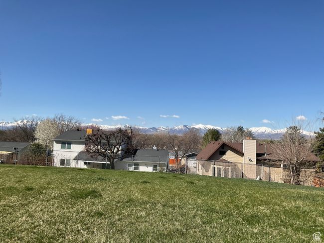 View of yard with fence and a mountain view | Image 8