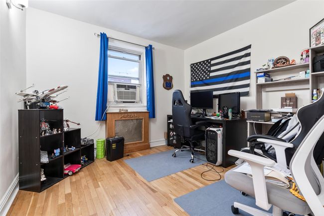 Office area with wood finished floors and cooling unit | Image 12