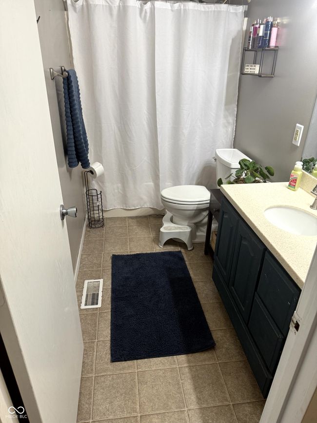 full bathroom with tile patterned flooring, toilet, and vanity | Image 22