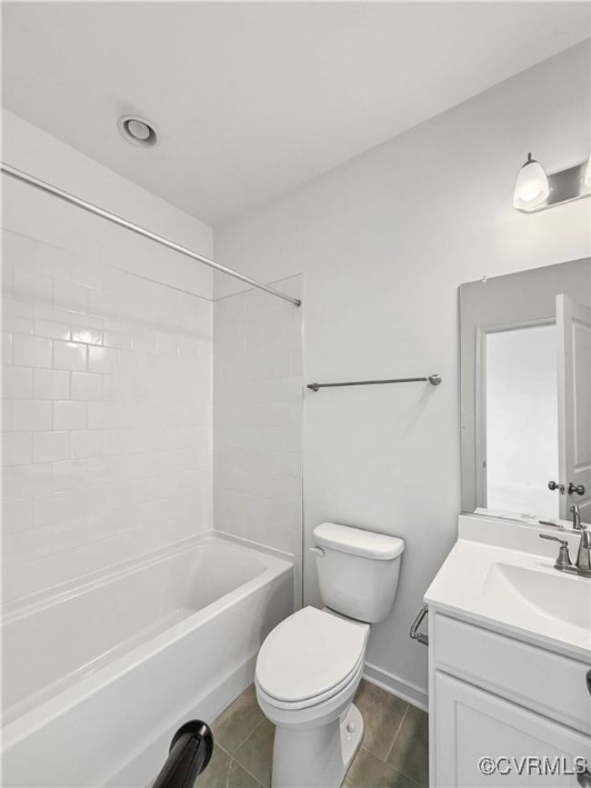 Full bath with vanity, shower / washtub combination, baseboards, toilet, and tile patterned flooring | Image 5