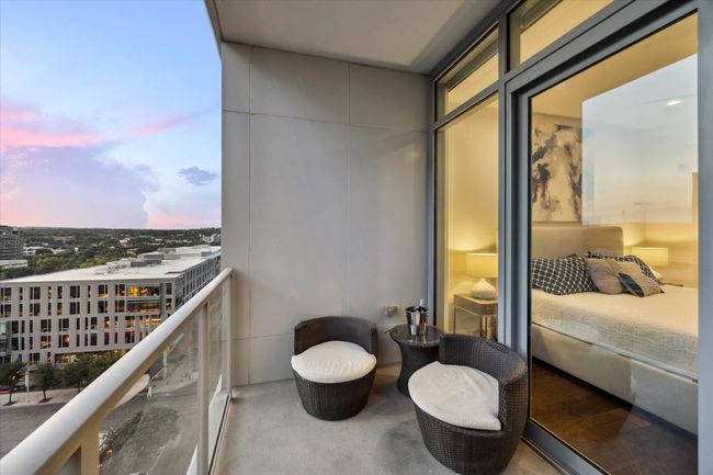Balcony at dusk with a view of city | Image 20
