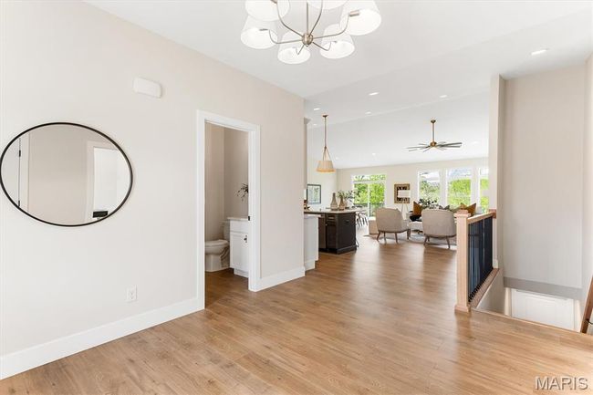 Entry foyer leading to the powder room, stairs to lower level, and vast open floor plan. | Image 13