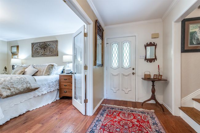 Entryway featuring light wood-style flooring, ornamental molding, and stairs | Image 6