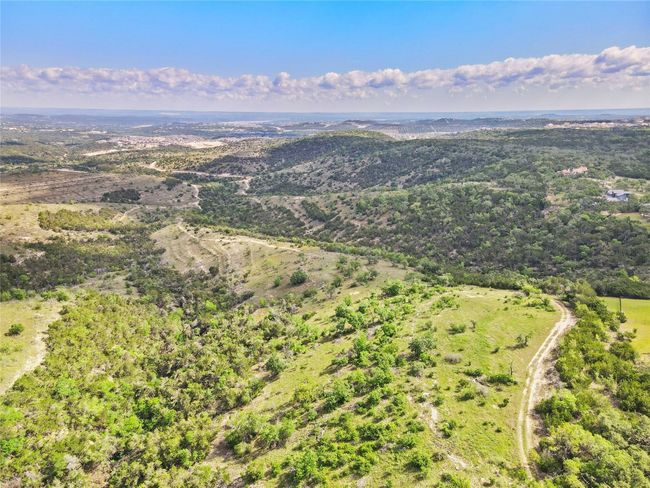 An ideal build site rests atop the summit, and the remainder of the property continues to slope lower and lower along your own private hillside. | Image 4