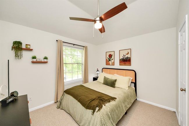 Step into the secondary bedroom, where natural light pours in through a large window, creating a bright and welcoming vibe. With generous space for flexible furniture layouts and a roomy closet for all your essentials, this room is as functional as it is inviting. | Image 34