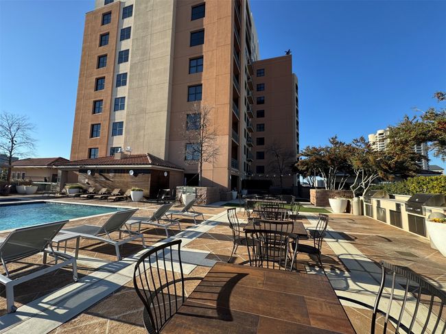 View of swimming pool featuring area for grilling, a patio, and exterior kitchen | Image 23