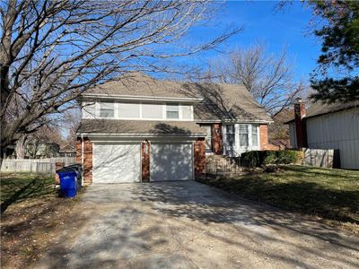 Split level home featuring a garage | Image 1