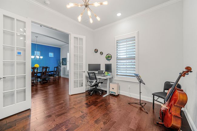 Office area featuring french doors, crown molding, wood finished floors, baseboards, and chandelier | Image 8