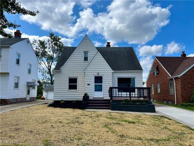 View of front of house featuring a deck and a garage | Image 1