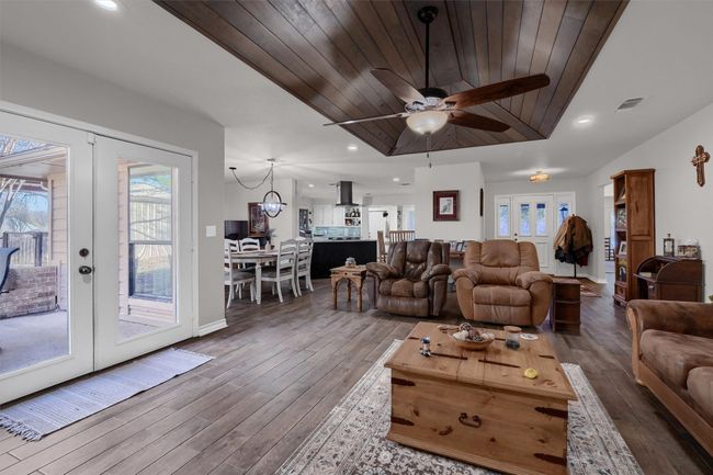 Living area with french doors, recessed lighting, wood finished floors, wood ceiling, and ceiling fan | Image 6