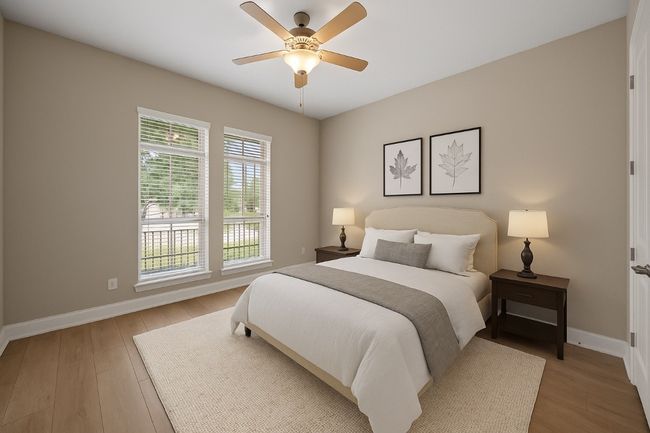 Bedroom with light wood finished floors and ceiling fan | Image 23