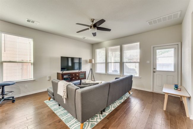 Another view of the family room showcasing the abundant natural light. | Image 5