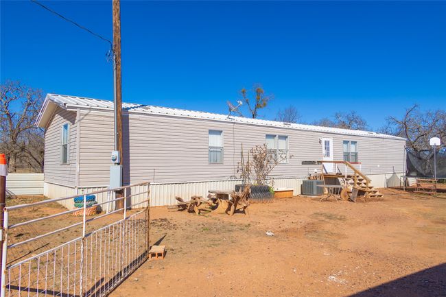 Rear view of house featuring a trampoline and central air condition unit | Image 18
