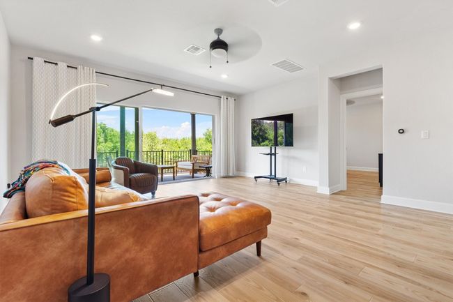 Living room with a ceiling fan, baseboards, light wood finished floors, and recessed lighting | Image 6