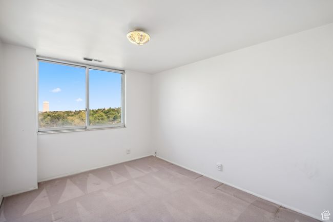 Spare room featuring light carpet and baseboards | Image 10